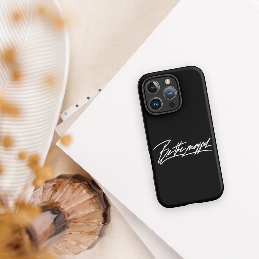Be The Mogger iPhone case on a desk